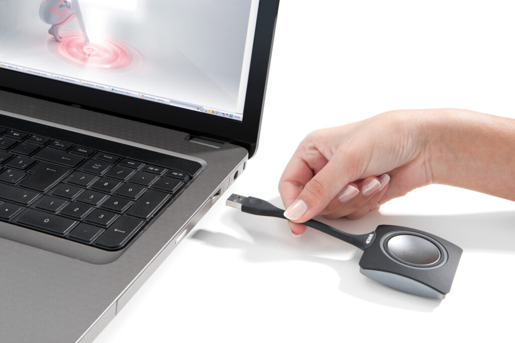 Person connecting ClickShare to laptop